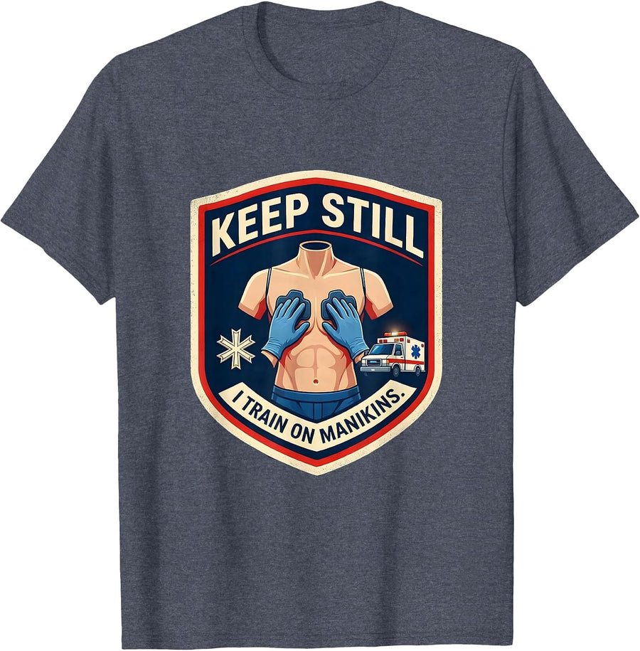 Keep Still I Train On Manikins Funny EMT Paramedic Gift T-Shirt - Heather Blue
